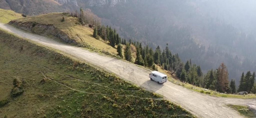 UAZ Buhanka on mountain road drone shot